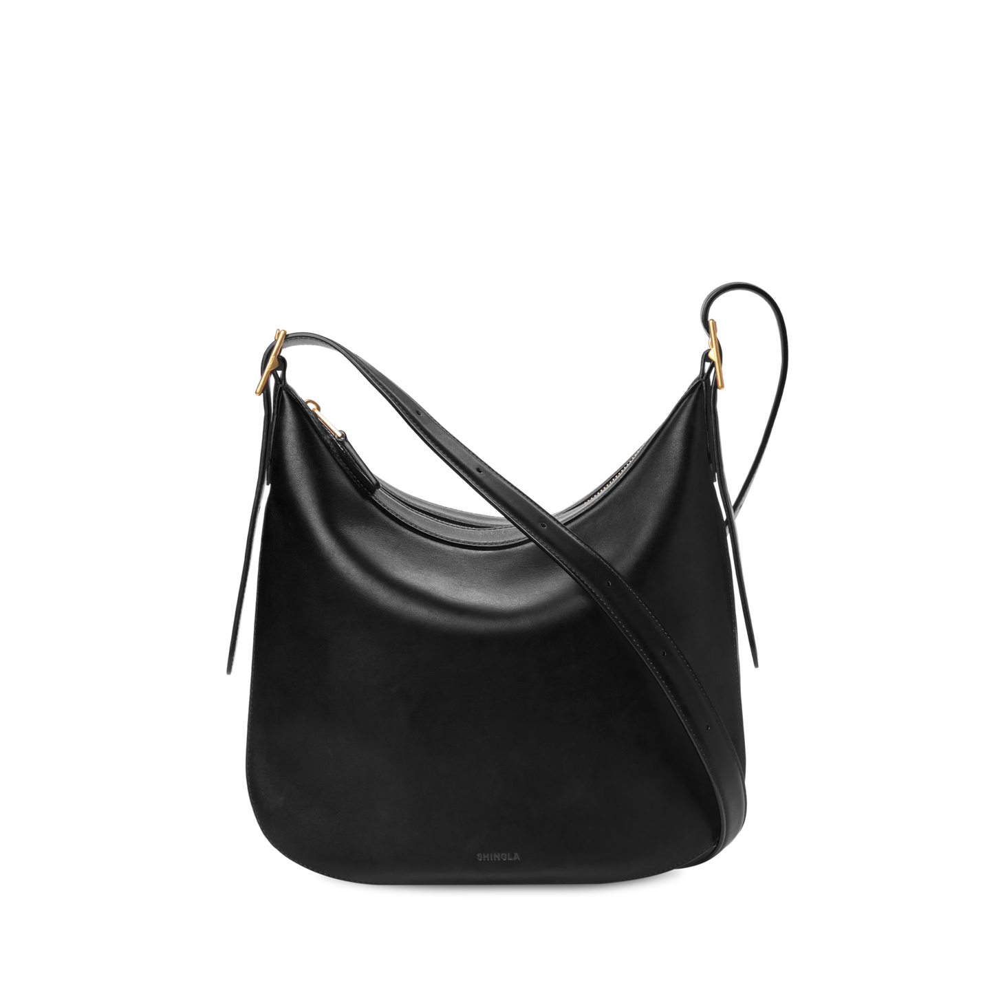 The Shinola Medium Bixby Crossbody - Black features a curved, slouchy shape in natural leather with gold-tone hardware and two adjustable straps, displayed against a plain white background.