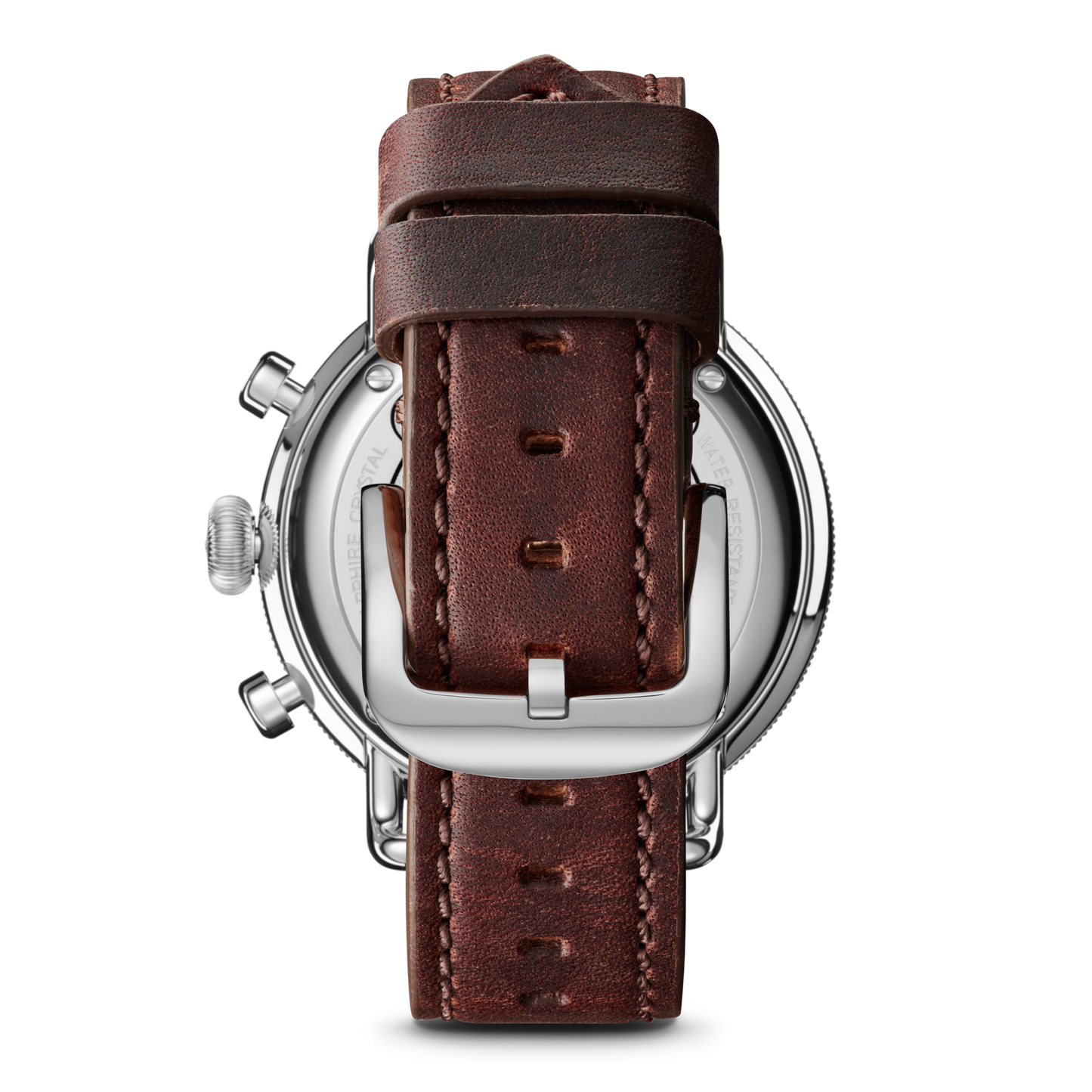 Close-up of the Shinola Canfield Chronograph Watch with a Cattail leather strap, showing visible stitching, a silver buckle, and the watch's top loaded case construction plus side buttons from the back.