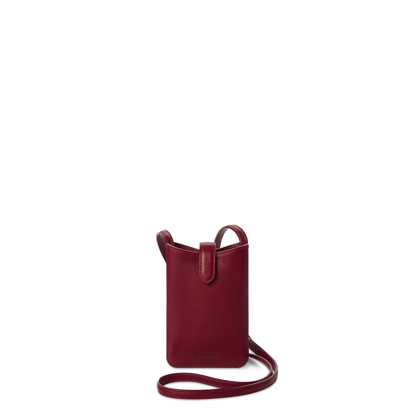 The Shinola Bixby Phone Crossbody in Ruby is a small, deep red natural leather bag with a slim strap, open top, and card slip pocket, shown against a plain white background.