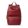 The Small Runwell Backpack - Ruby by Shinola, made from red Natural Grain Leather with a pebbled finish, features a front zippered pocket, main compartment, and top handle against a plain white background.