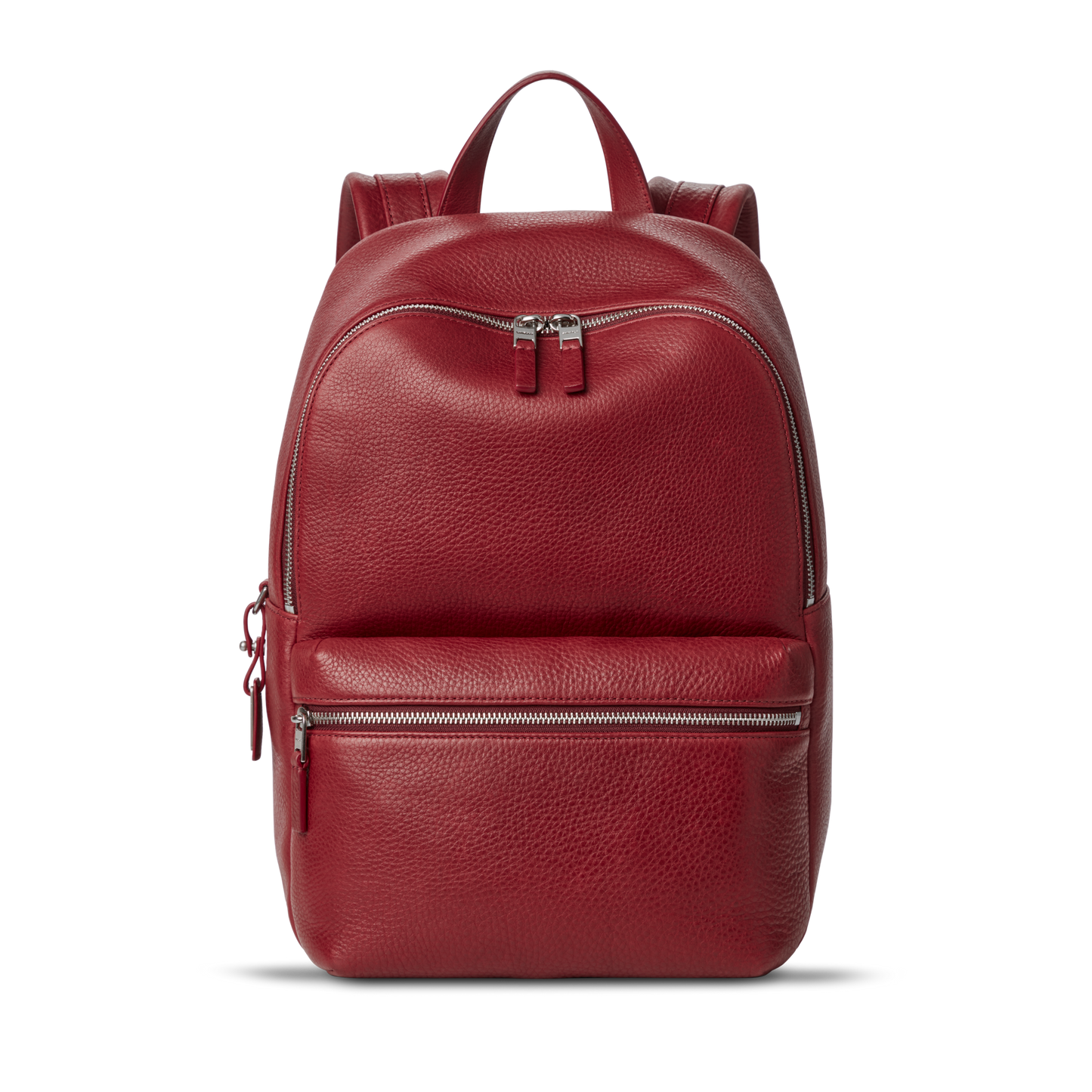 The Small Runwell Backpack - Ruby by Shinola, made from red Natural Grain Leather with a pebbled finish, features a front zippered pocket, main compartment, and top handle against a plain white background.