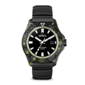 The Shinola Forged Carbon Monster Watch features a black dial with white hour markers, date display, luminous hands, a black and green marbled bezel, forged carbon case, black rubber strap, and Swiss automatic movement.