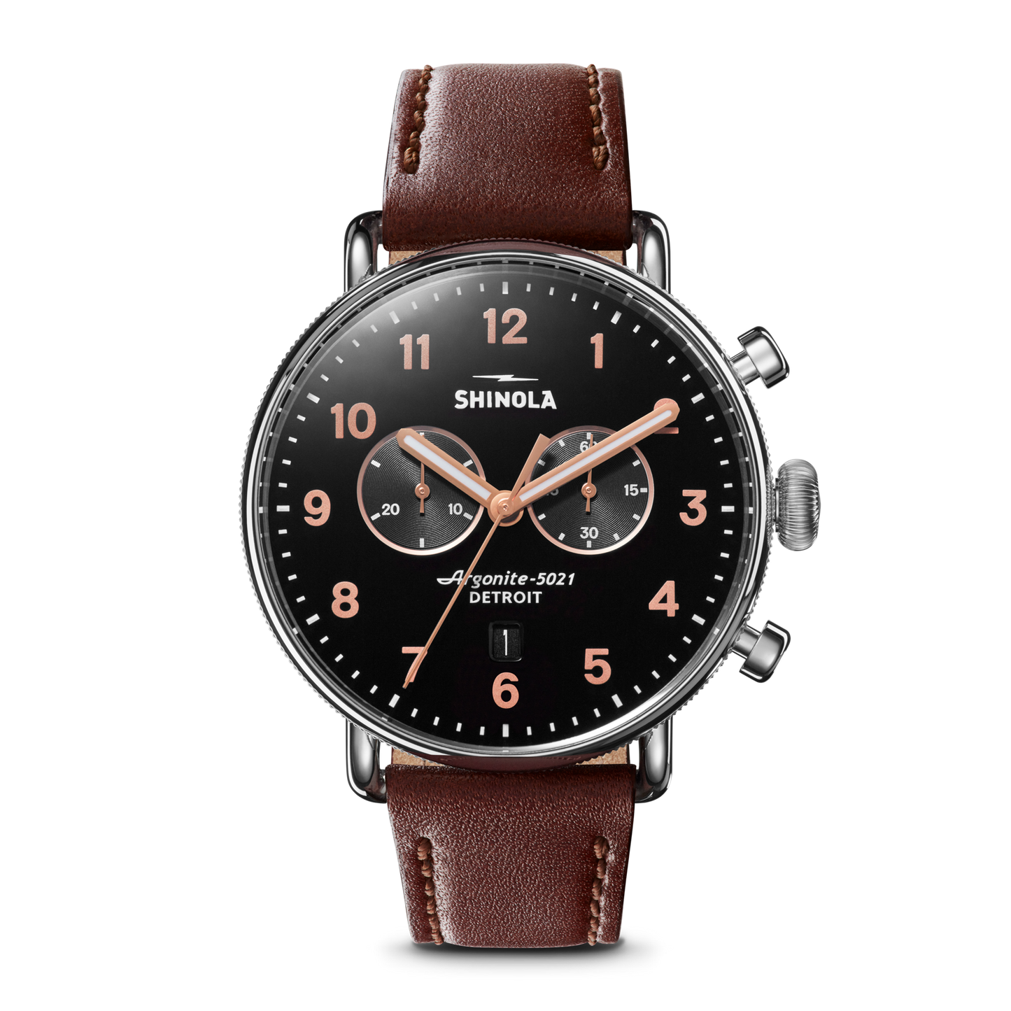 The Shinola Canfield 2 Eye Chrono - Black features a black dial, rose gold hands and numbers, two subdials, date window, brown leather strap, stainless steel silver case, and two buttons on the right side.