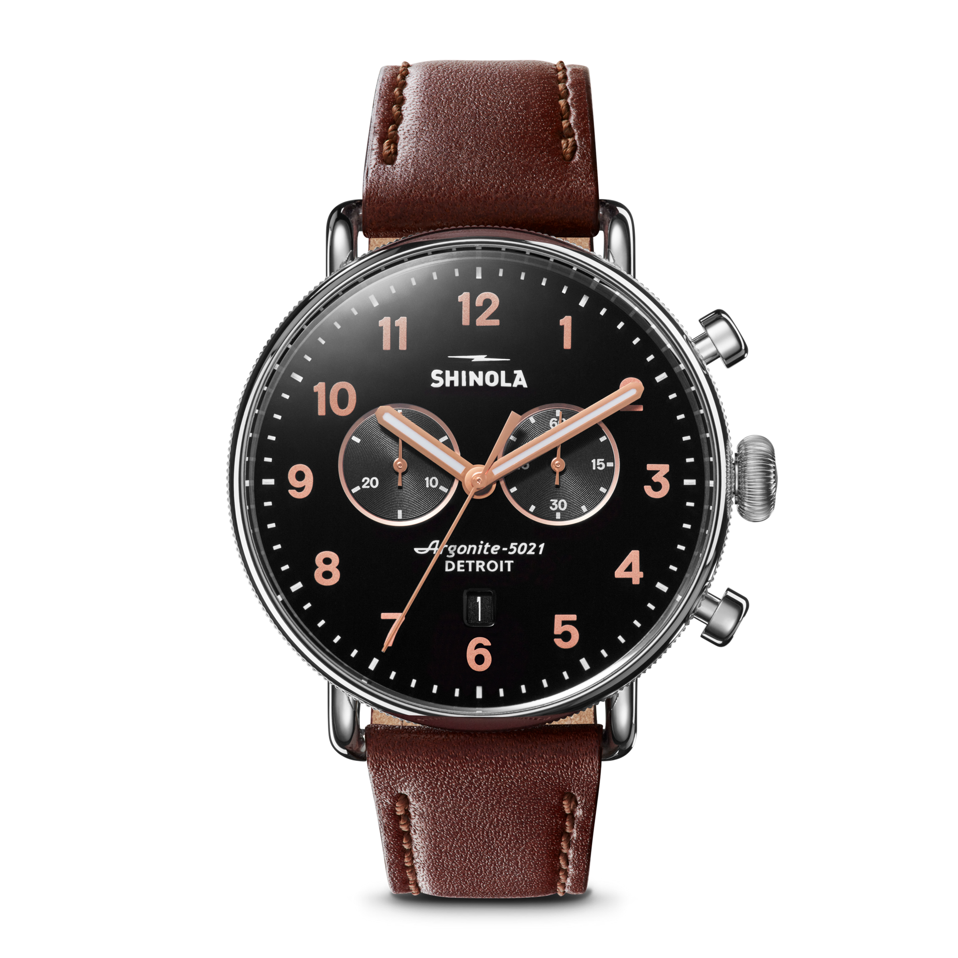 The Shinola Canfield 2 Eye Chrono - Black features a black dial, rose gold hands and numbers, two subdials, date window, brown leather strap, stainless steel silver case, and two buttons on the right side.