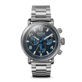 The Shinola Runwell Chronograph West Wind Watch Gift Set features a 42mm silver stainless steel case, blue luminous dial with three subdials, white numerals, Argonite-5050 movement, branding, bracelet strap, and extra strap included.