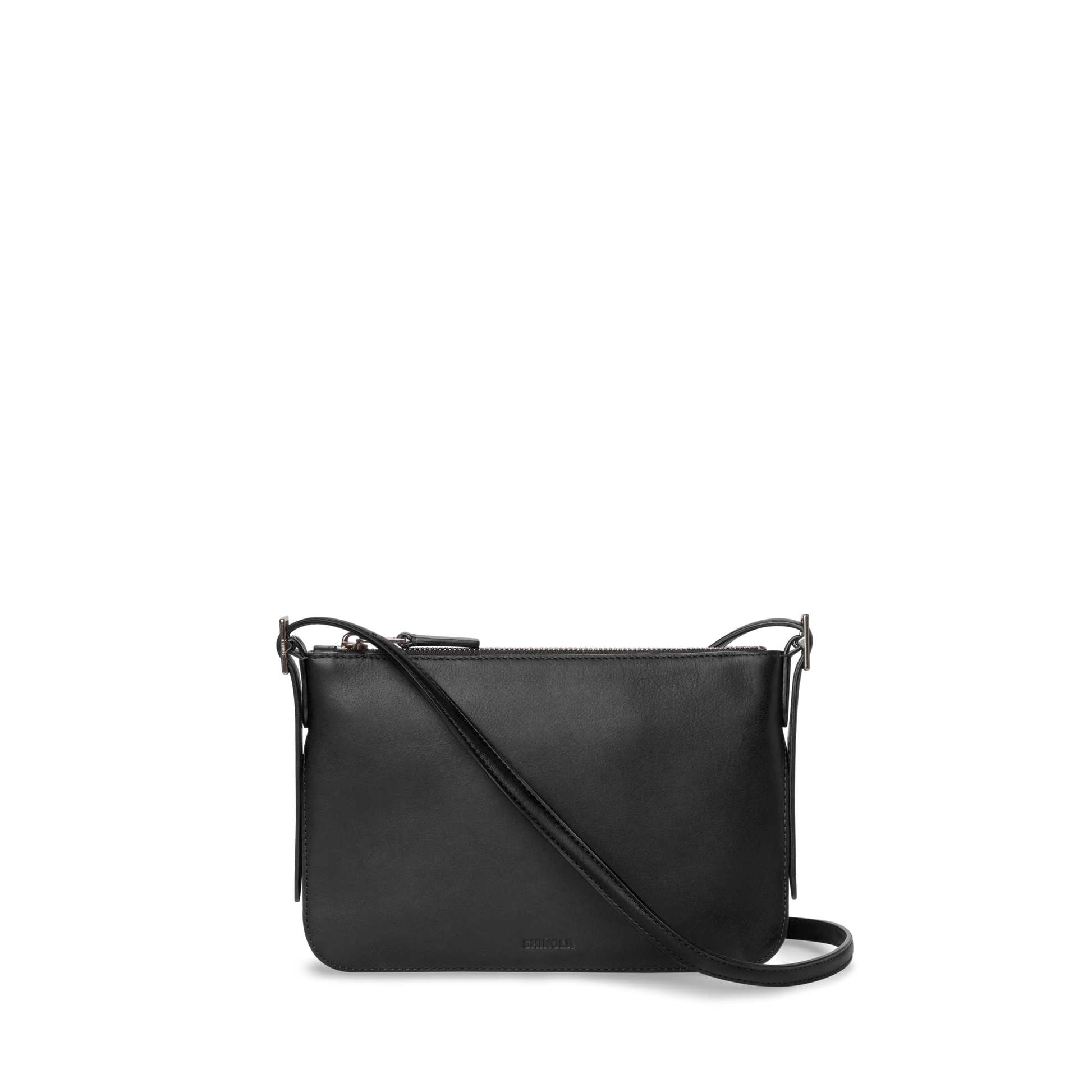 The Shinola Small Bixby Crossbody - Black is a slim natural leather bag with a zipper closure and adjustable strap, making it an ideal everyday accessory. Shown here against a plain white background.