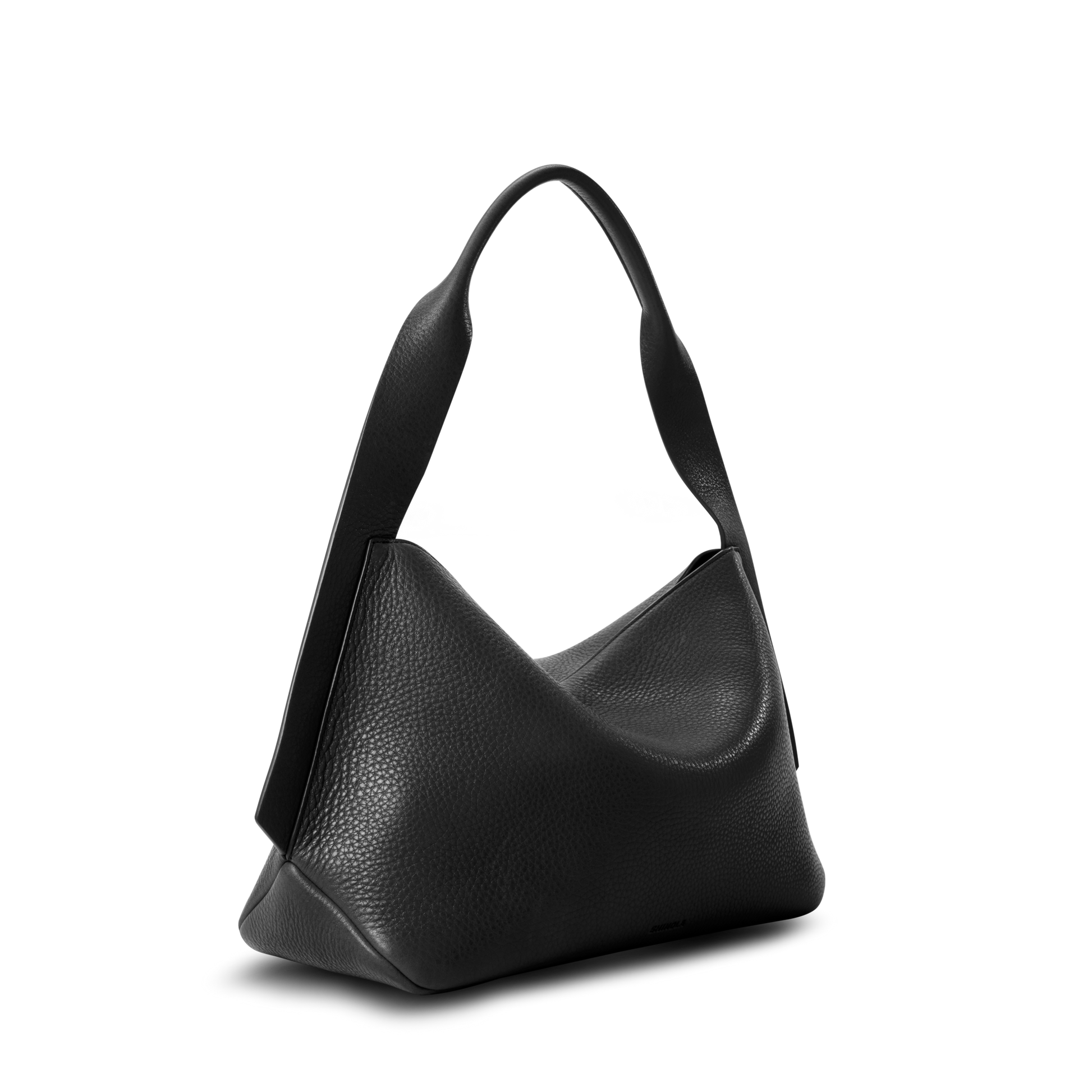 The Shinola Medium Derby Shoulder Bag - Black is crafted from natural grain leather with a wide, structured handle, slouchy sculptural shape, and secure zip closure, shown against a plain white background.