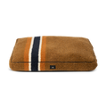 The Shinola Napper Pillow Dog Bed - Stripe Brown features orange, cream, and dark blue lengthwise stripes, a soft plush texture, memory fiber fill for comfort, a small black front label, and a machine washable cover for easy cleaning.