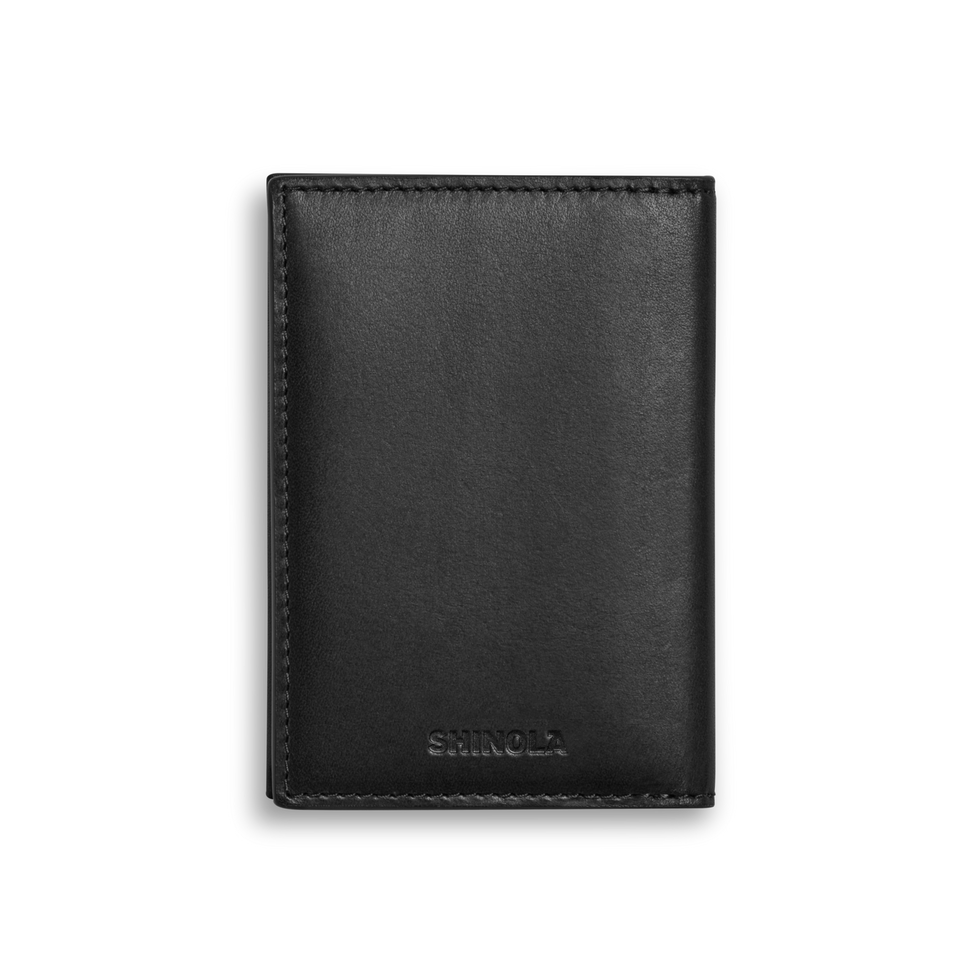 A closed Folded Card Holder Wallet - Black by Shinola, crafted from Italian Vachetta leather with "Shinola" embossed at the bottom center, shown on a plain white background.