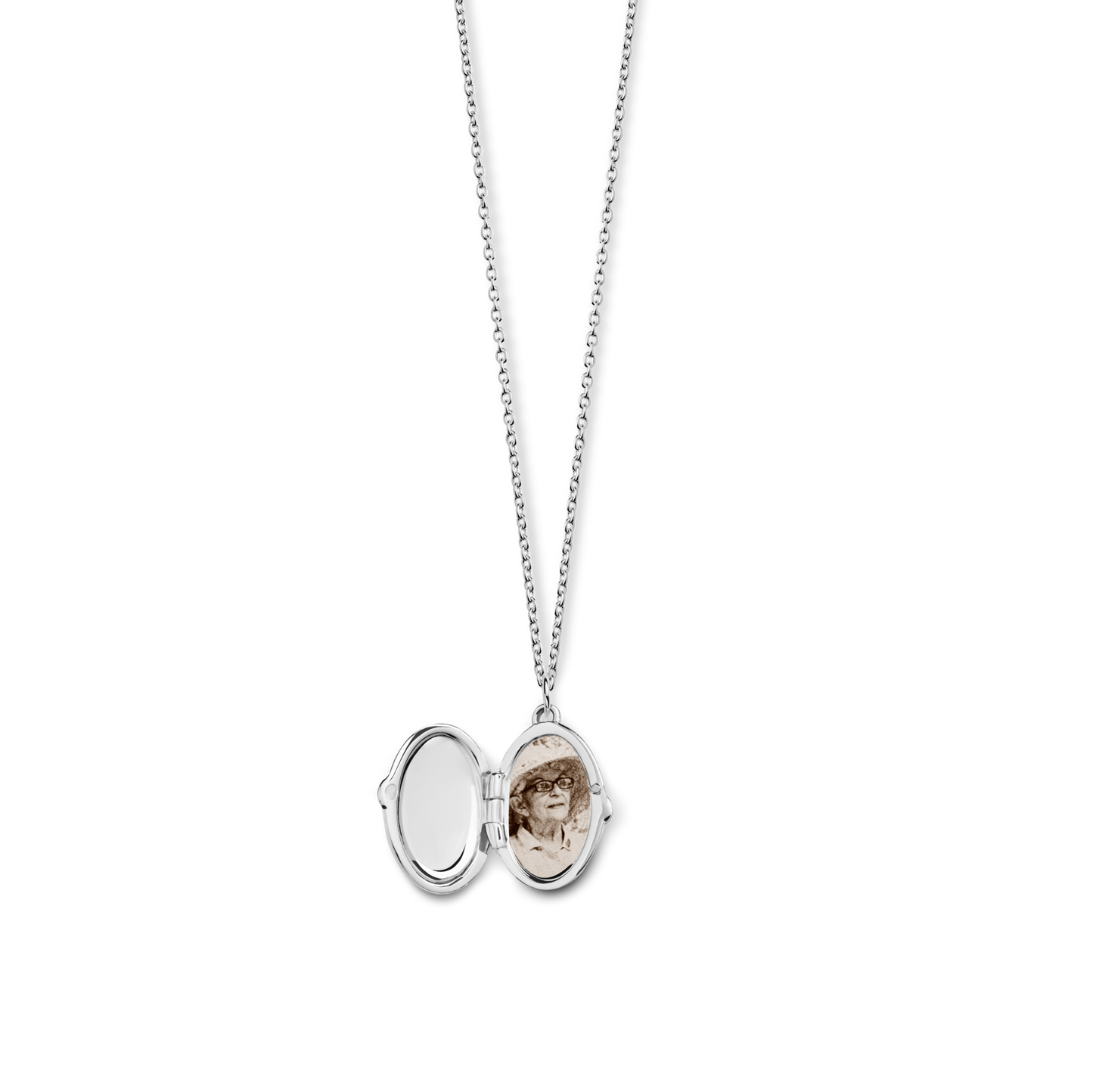 The Shinola Heirloom Petite Locket Necklace in sterling silver opens to reveal a sepia photo on one side and an empty, engravable space on the other—ideal for preserving cherished memories.
