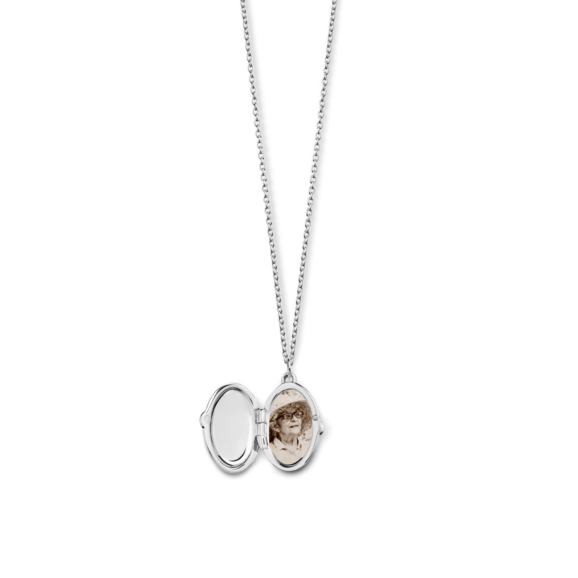 The Shinola Heirloom Petite Locket Necklace in sterling silver opens to reveal a sepia photo on one side and an empty, engravable space on the other—ideal for preserving cherished memories.