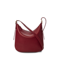 The Shinola Medium Bixby Crossbody - Ruby features natural leather in a curved, crescent shape with gold-tone hardware and an adjustable strap. This versatile shoulder bag is shown against a plain white background.